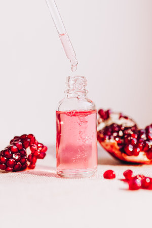 Pomegranate oil in a cosmetic bottle with a pipette. natural cosmetics and face care.の写真素材