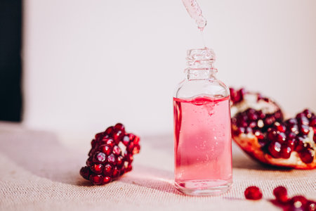 Pomegranate oil in a cosmetic bottle with a pipette. natural cosmetics and face care.の写真素材