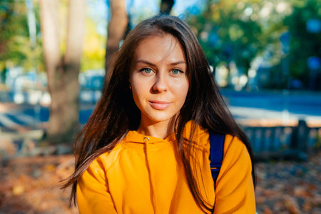 Portrait of a happy smiling young woman while walking outdoors.の写真素材