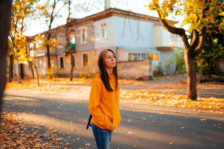 Portrait of a happy smiling young woman while walking outdoors.の写真素材