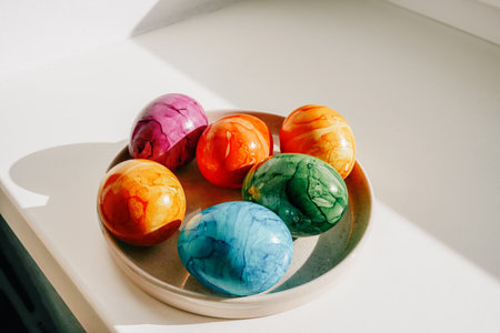 Vibrant Easter eggs featuring marbled colors displayed on a light background.の写真素材