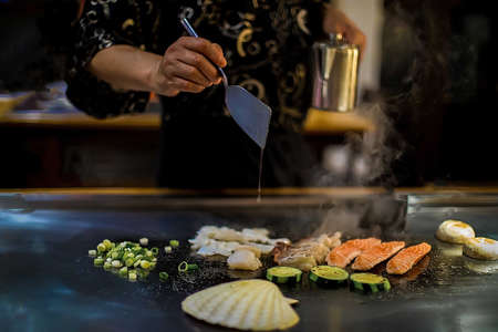teppan show in a Japanese restaurant, cooking directly in front of the client, fish, rice, meat, vegetablesの写真素材