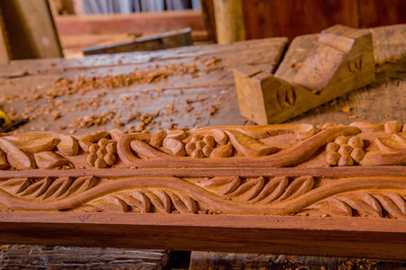 Stone Town, Zanzibar, Tanzania. March 27, 2018. Master woodcarver at work. Wood shavings, gouges and chisels on the workbench. close up. master's hands at workのeditorial素材