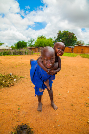 Kenya Africa ,16 oktober 2019. two little African girls from the Maasai tribe in national clothes are very poorly dressedのeditorial素材