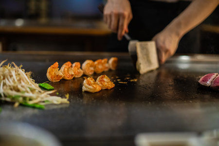 Tepanyaki - japanese grilled beef on pan. chef cooking at the hot tableの写真素材
