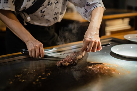 Tepanyaki - japanese grilled beef on pan. chef cooking at the hot tableの写真素材