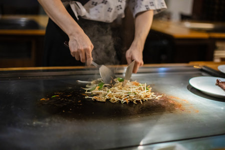 Tepanyaki - japanese grilled beef on pan. chef cooking at the hot tableの写真素材