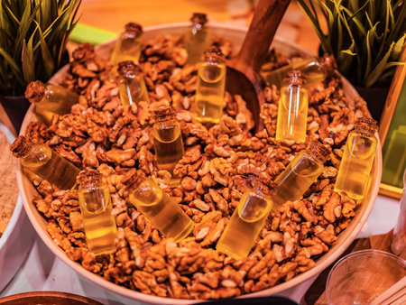 Walnut oil in glass of bottle, whole big peeled walnut kernel without shell. Oil and nuts background. super food healthy conceptの写真素材