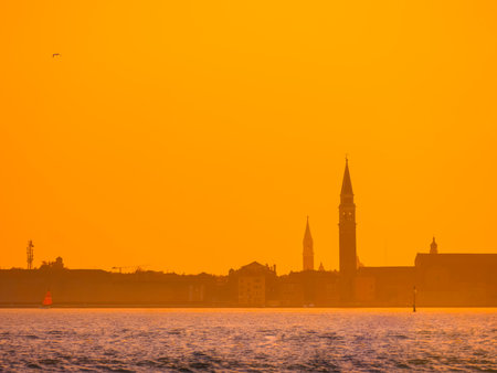 Venice, Italy. 29 october 2022. silhouettes of Venice at sunset in the bright warm orange-red rays of the setting sun. view from the waterの写真素材
