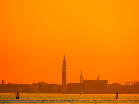 Venice, Italy. 29 october 2022. silhouettes of Venice at sunset in the bright warm orange-red rays of the setting sun. view from the waterの写真素材