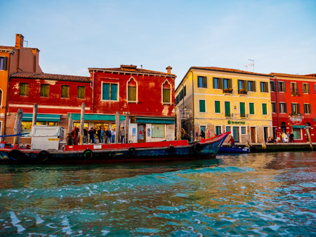 Venice, Italy. 29 october 2022. silhouettes of Venice at sunset in the bright warm orange-red rays of setting sun. view from the water. bright colored houses on banks of canal at sunsetの写真素材