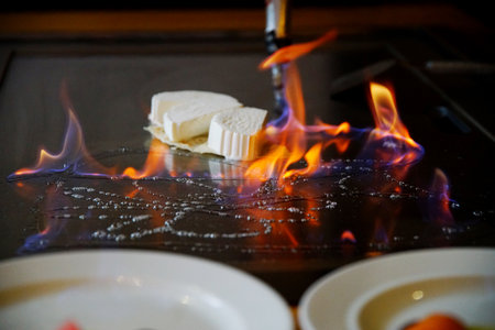 chef's hands with spatula over teppanyaki. cooking vegetables meat and seafood on hot hibachi grill table. Traditional Japanese. Teppan show. cuisine peoples of world conceptの写真素材