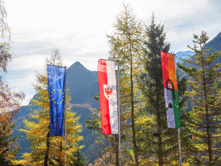 Austria, Europe. 10/27/2022. bright autumn landscape, view of the Austrian Alps. road to Italy on a sunny day. Clear blue sky, the slopes are covered with autumn forestの写真素材