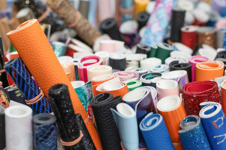 Stacks of vibrant rolls featuring various textures and colors, creating an inspiring atmosphere for...