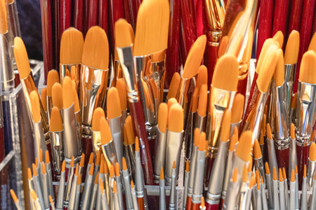 A vibrant collection of paintbrushes featuring orange bristles, displayed together, showing artistic tools for creativity and inspiration.の写真素材