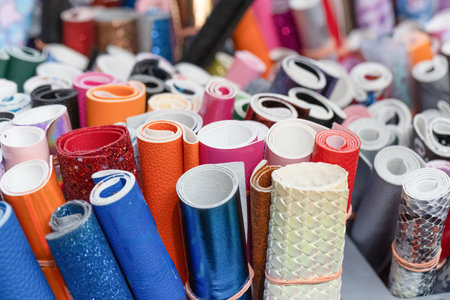 A vibrant assortment of rolled materials in various textures and colors, perfect for creative...