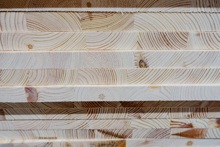 Close-up view of layered wooden planks displaying intricate grain patterns and natural colors, ideal...