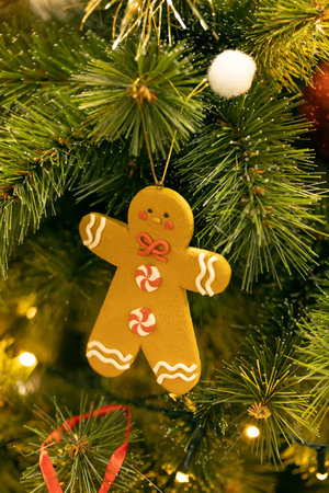Gingerbread man ornament is beautifully displayed on a Christmas tree, surrounded by vibrant...