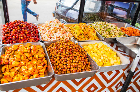 Various street food options in the capital of Sri Lanka. Fruits with spices, fried pies, salads....