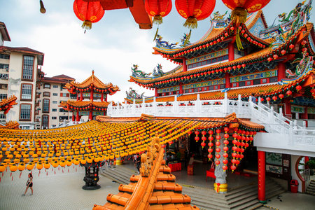 Kuala Lumpur, Malaysia. 08/07/2024. Largest Buddhist temple Thean Hou, Kuala Lumpur. Facade decorated with Chinese dragon and gray stone figures around.の写真素材