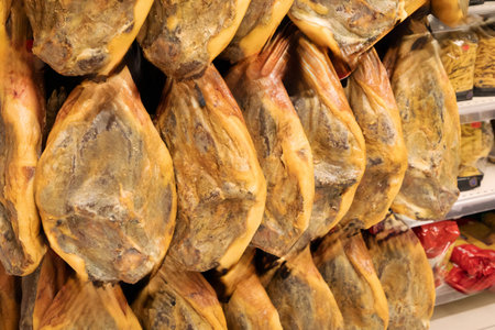 Tenerife, Spain - November 13, 2024: Jamon Iberico is displayed in a market, highlighting its rich texture and cultural significance.の写真素材