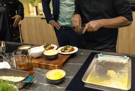 . Chef is skillfully preparing gourmet dishes in a contemporary kitchen, showcasing fresh...