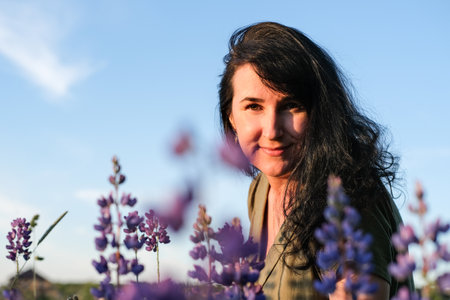Portrait of a young woman in purple flowers. Summer lifestyle
