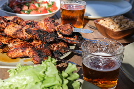 Summer picnic with barbecue, vegetables and beerの写真素材