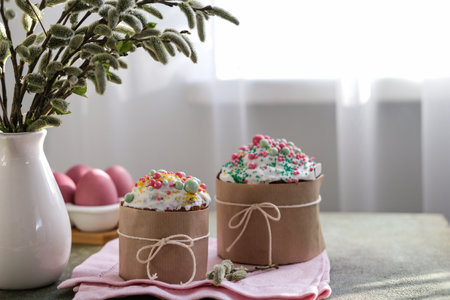 Easter cakes and painted Easter eggs on the table by the window. Easter traditions