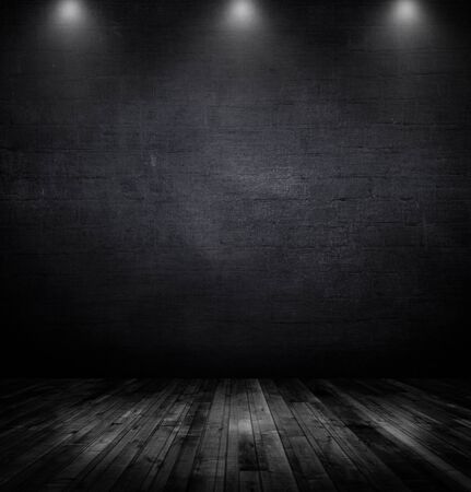 Wood table and black wall background with spotlightsの写真素材