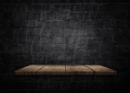 Wooden shelf on black brick background 3d illustrationの写真素材