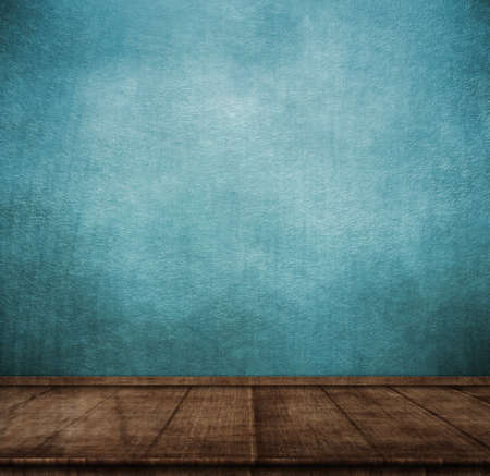 Wooden table on blue wall in vintage style on dark background. Abstract background. Vintage style....