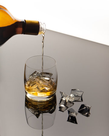 rum in a glass with ice cubes. Motionの写真素材