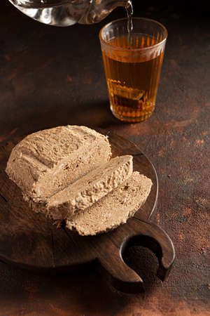 Halva traditional local confection recipes in West Asia. On a cutting board with tea