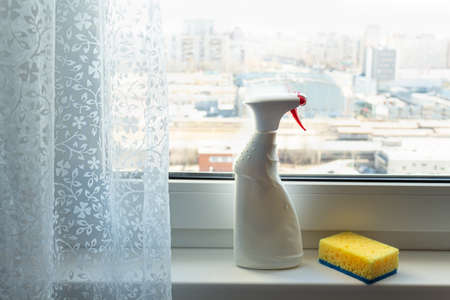 window cleaner detergent on the windowsill, washing window. Mock-upの写真素材