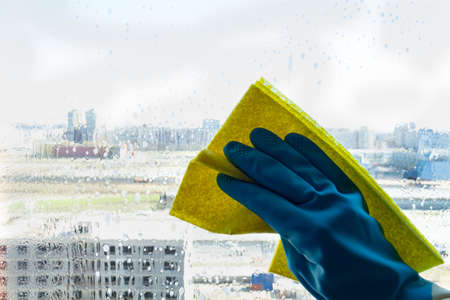 window cleaner detergent on the windowsill, washing window. Mock-upの写真素材