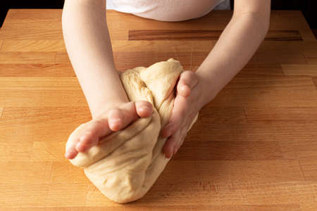 baby knead dough on a wooden board