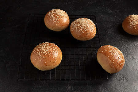 ready-made burger buns on a wooden cutting board. Home cookingの写真素材