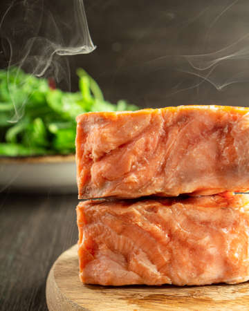 hot grilled salmon cut on a cutting boardの写真素材