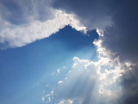 blue sky with clouds and rays of sunshineの写真素材