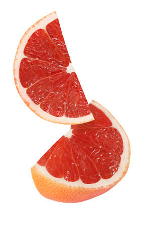 hanging, falling and flying piece of grapefruit fruits isolated on white backgroundの写真素材