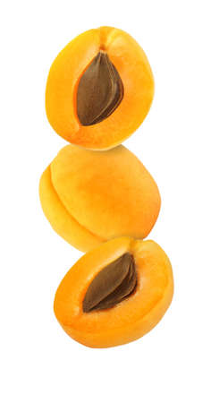 hanging, falling, hovering and flying whole and sliced apricot isolated on white backgroundの写真素材