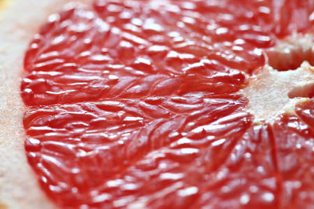 Grapefruit fresh fruit cut in half, red insides. Top view with bokeh effect