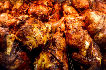 Grilled chickens cooked, whole chicken fried, piled in bulk, in supermarket.の写真素材