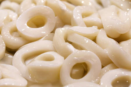 Squid rings, fresh raw many pieces chilled, at the fish market.の写真素材