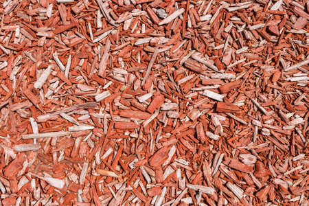 Wood chips in bulk, red decorative sawdust, chip background patternの写真素材