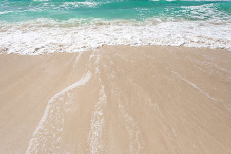 Sea, turquoise water, surf on a sandy beach