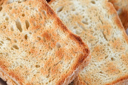 Croutons or bread toasts close-up view fried on grill