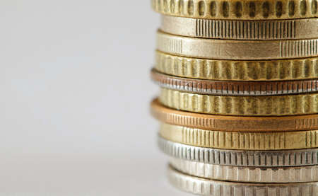 Coins old made of white and yellow metals, stacked in pile, side view of ribs, close-up macro