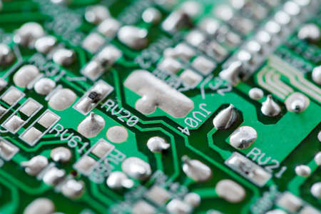 Electronic printed circuit board green with copper tracks, macro close-up, selective focusの写真素材